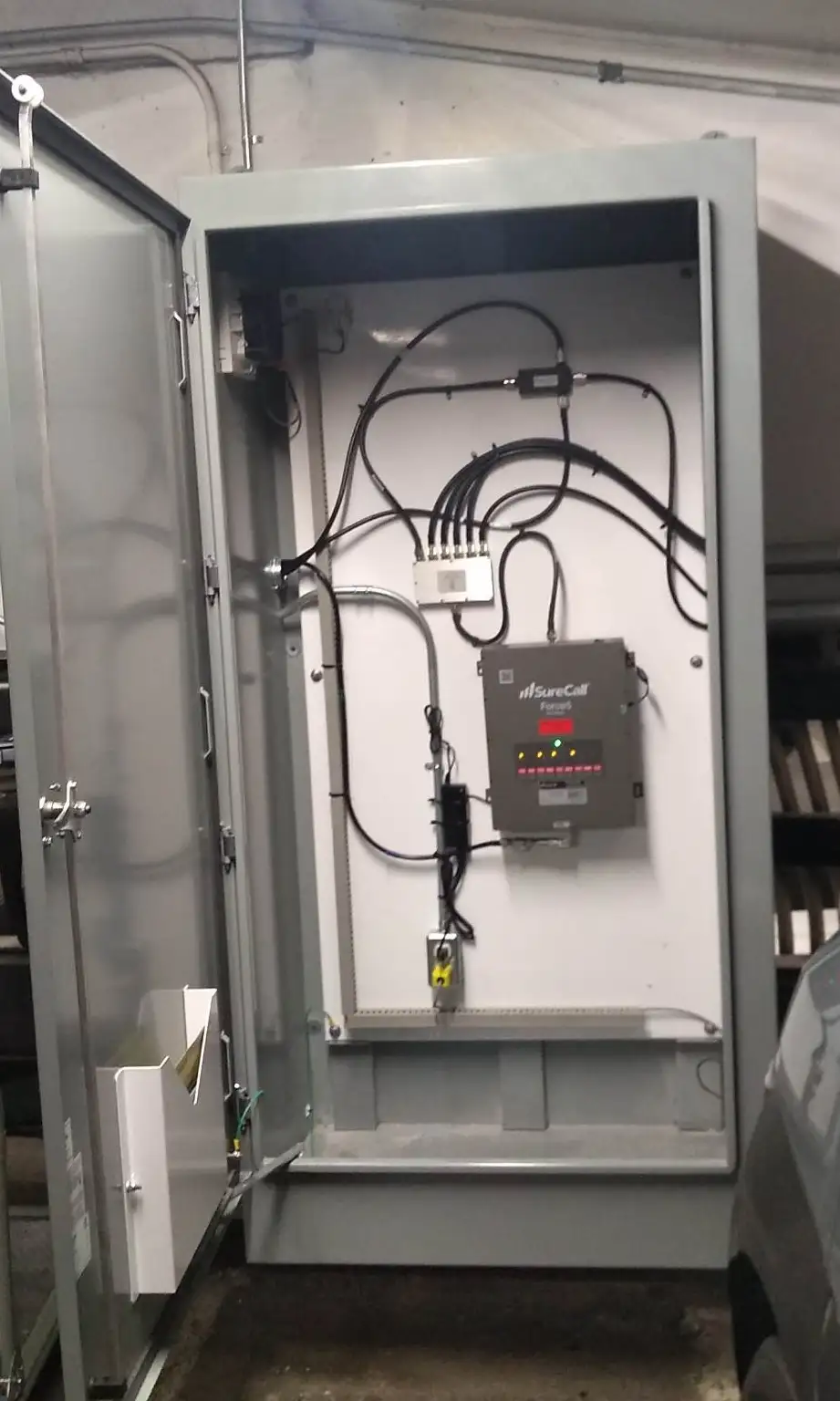Force5 booster installed and powered inside a locked cabinet in a parkade.